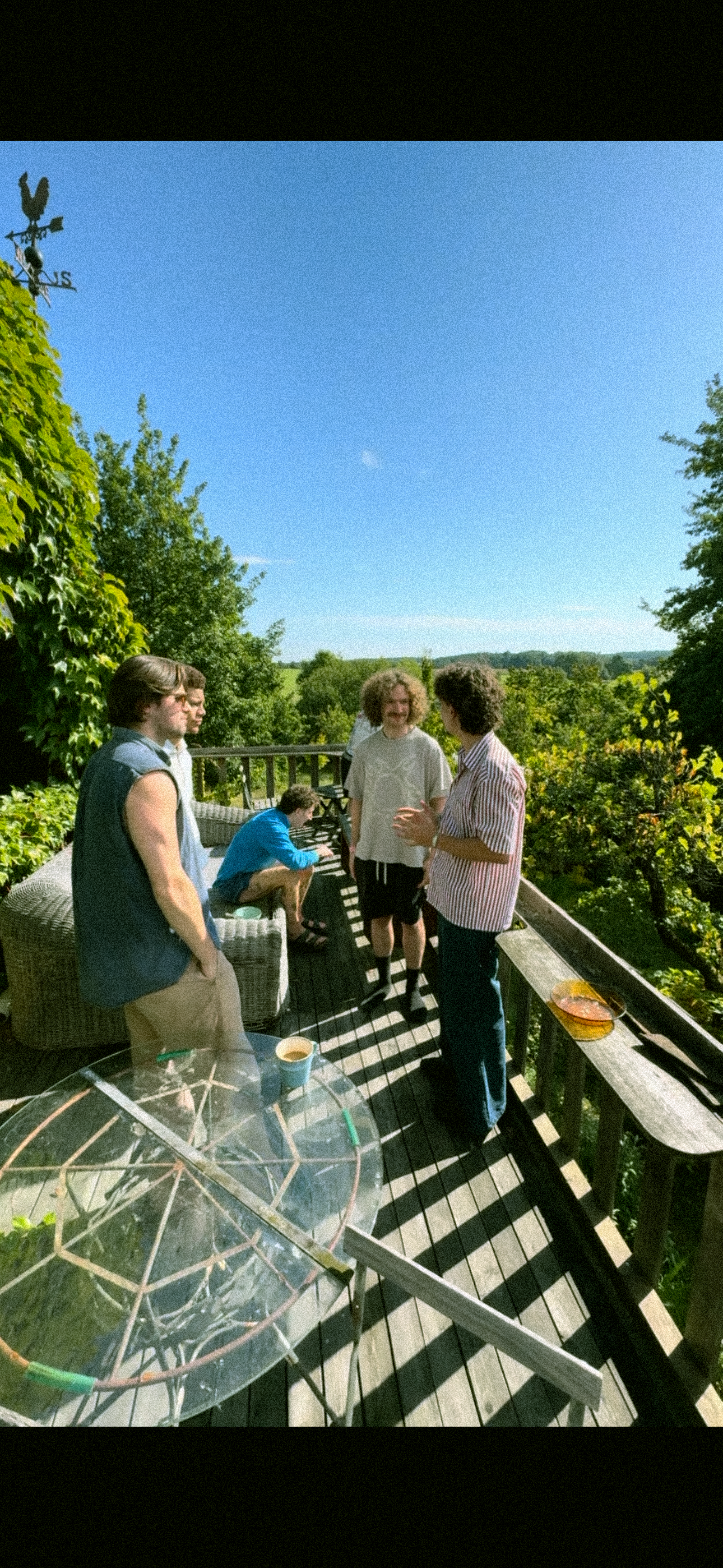 QUIETLOUD members spending time together on a sunlit terrace